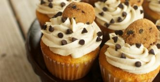 Chocolate Chip Cookie Dough Cupcakes - A delicious vanilla cupcake topped with chocolate chip cookie dough frosting with a cookie dough surprise in the center. These are one of my favorite cupcakes I've ever made!