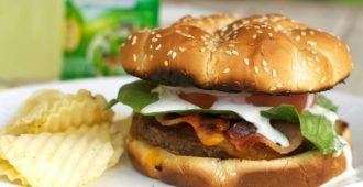 Bacon Ranch Burger - A juicy cheeseburger topped with crispy bacon and a tangy ranch dressing. Perfect for a summer BBQ!