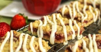 Strawberry Crumb Bars - A crispy cookie crust layered with sweet strawberries, buttery crumble, and a white chocolate glaze. A perfect summer dessert!