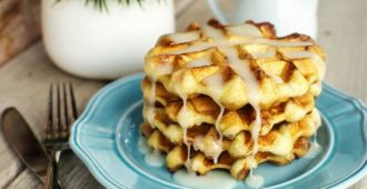 Easy Cinnamon Roll Waffles - You're going to love how easy it is to make these waffles! A fun twist on an ooey gooey cinnamon roll.